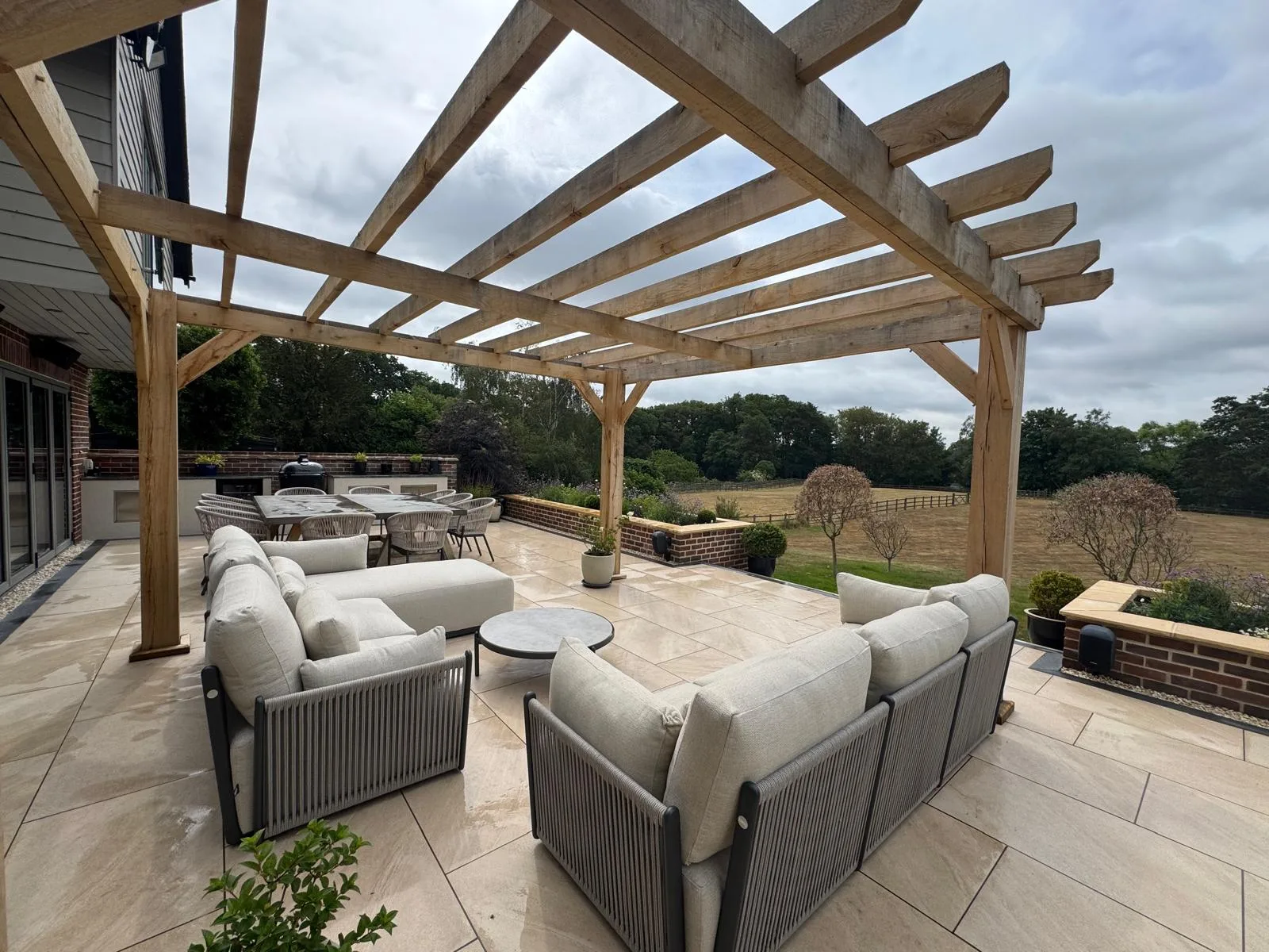 Oak pergola over a porcelain patio in Essex