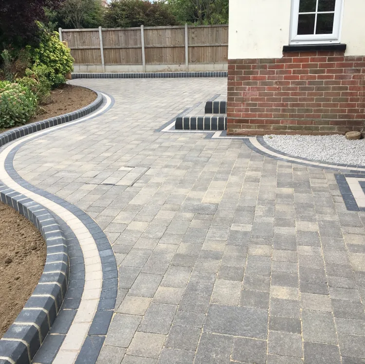 Curved block-paved driveway with charcoal and cream border in Essex