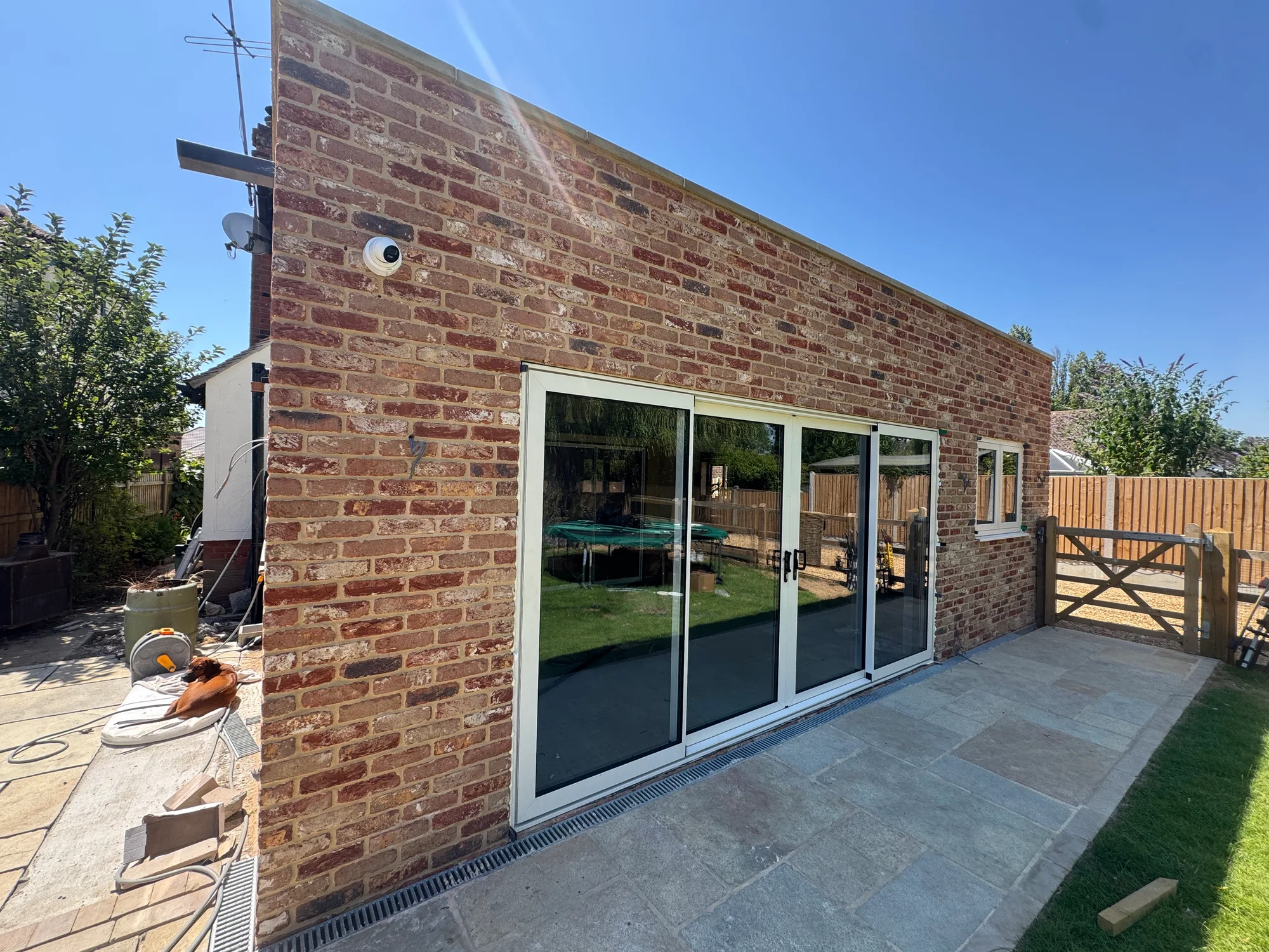 Single-storey brick rear extension with bifold doors built in Essex