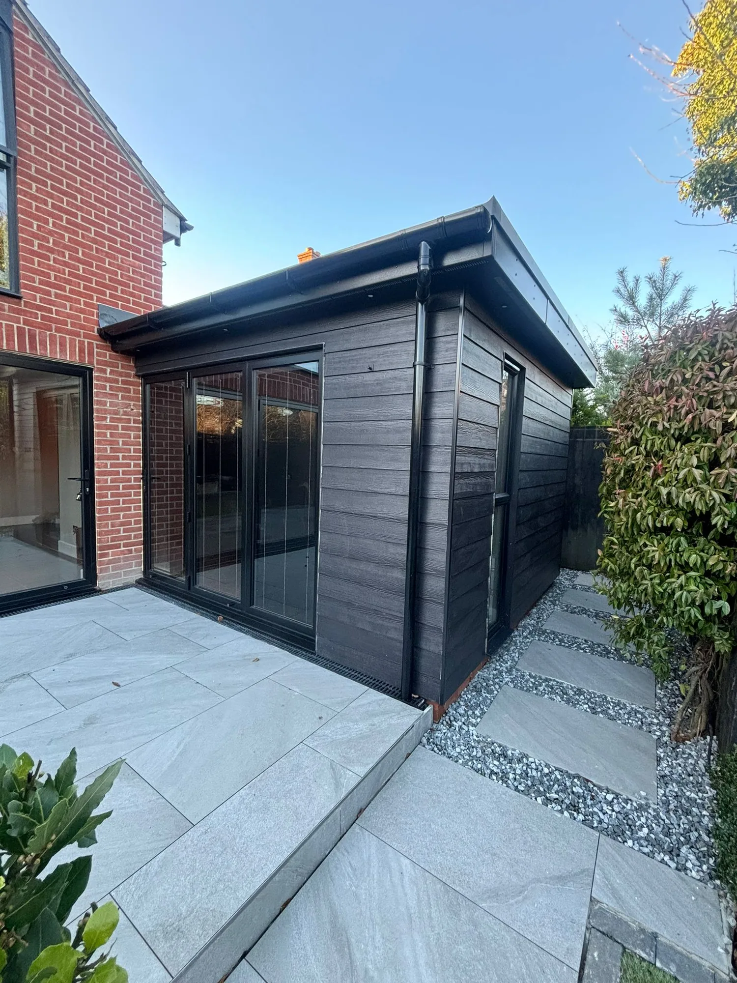 Finished composite clad garden room extension with bifold doors in Essex