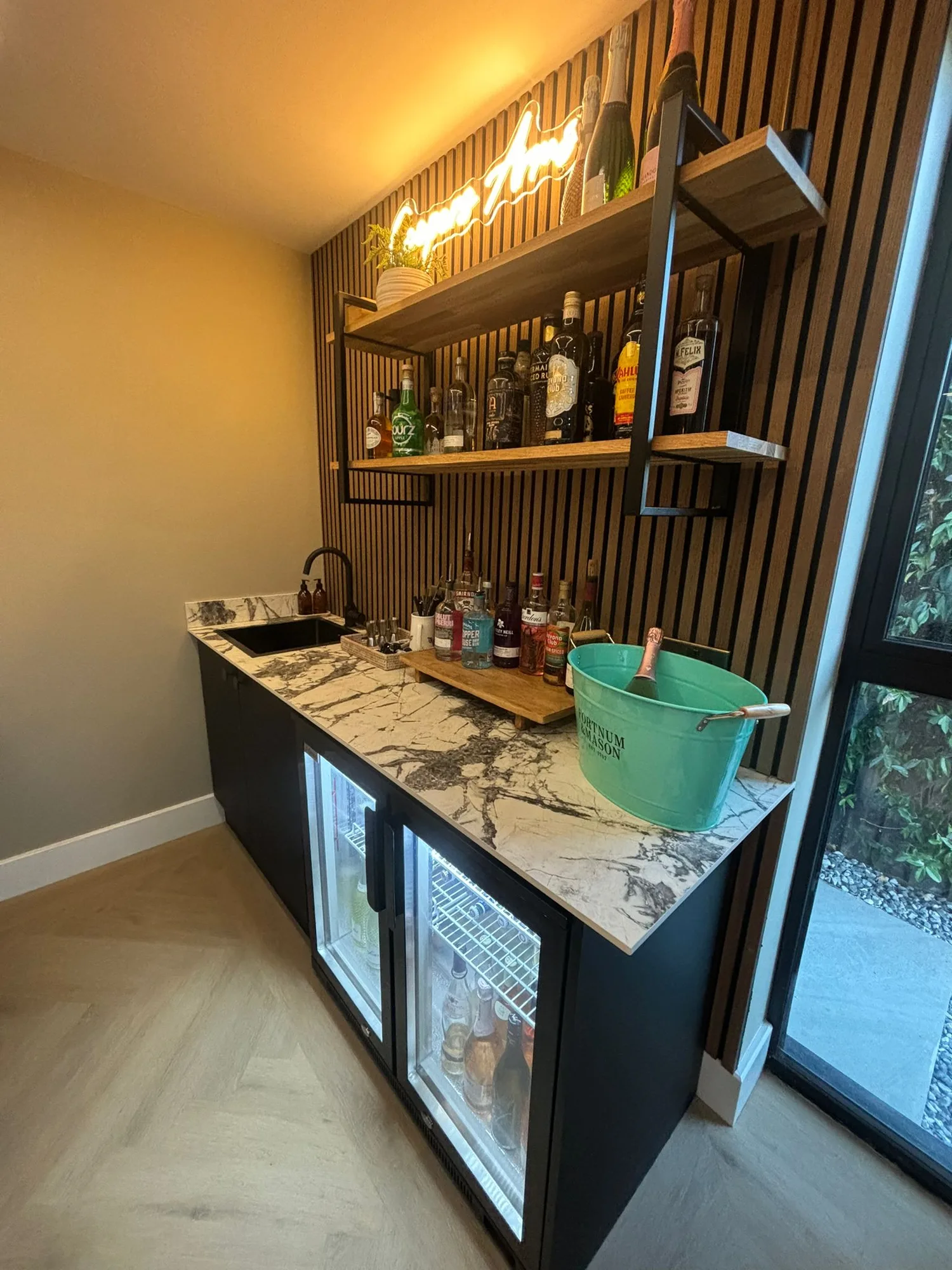 Fitted home bar detail with marble worktop inside an extension in Essex