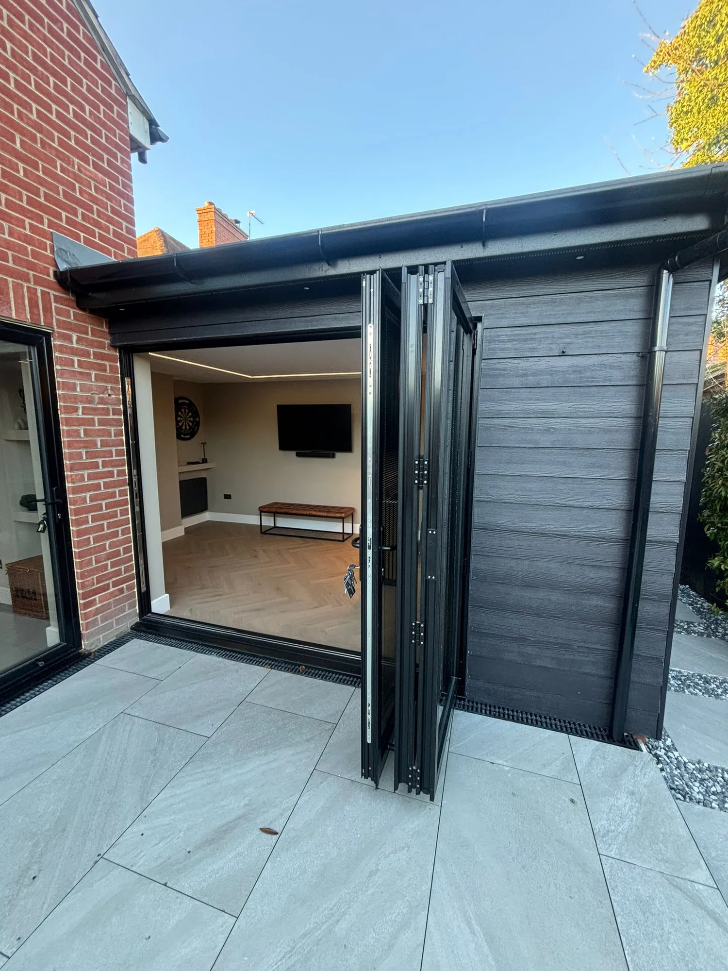 Bifold doors folding open on a garden room extension in Essex