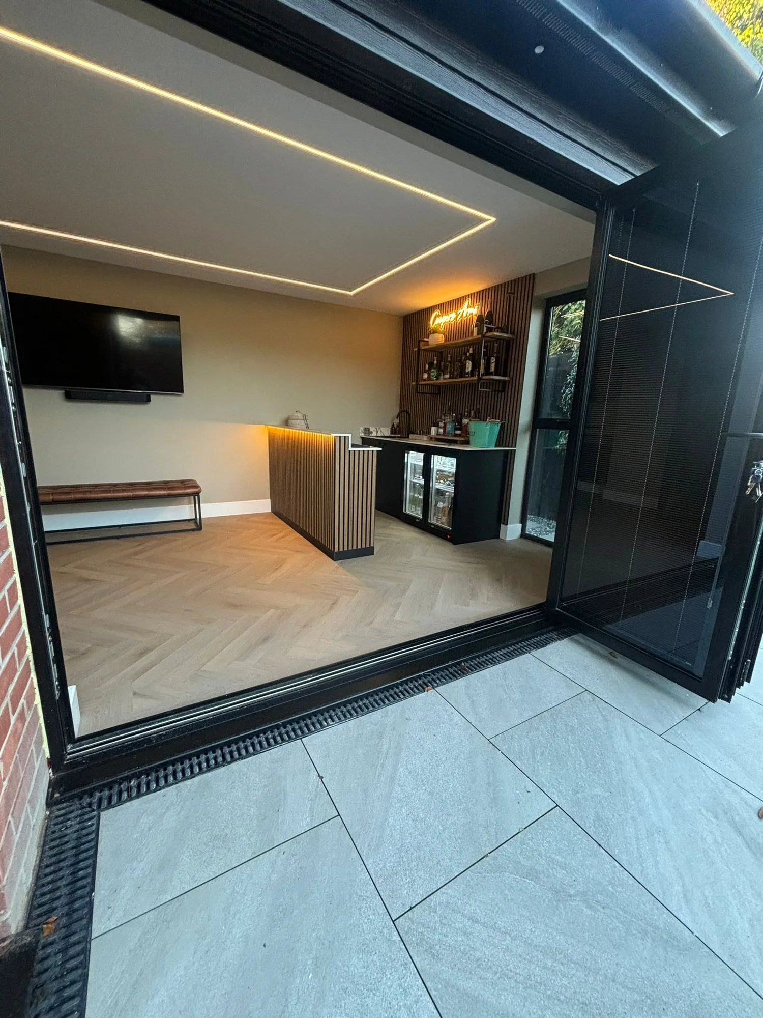 Garden room extension interior with home bar viewed from the patio in Essex