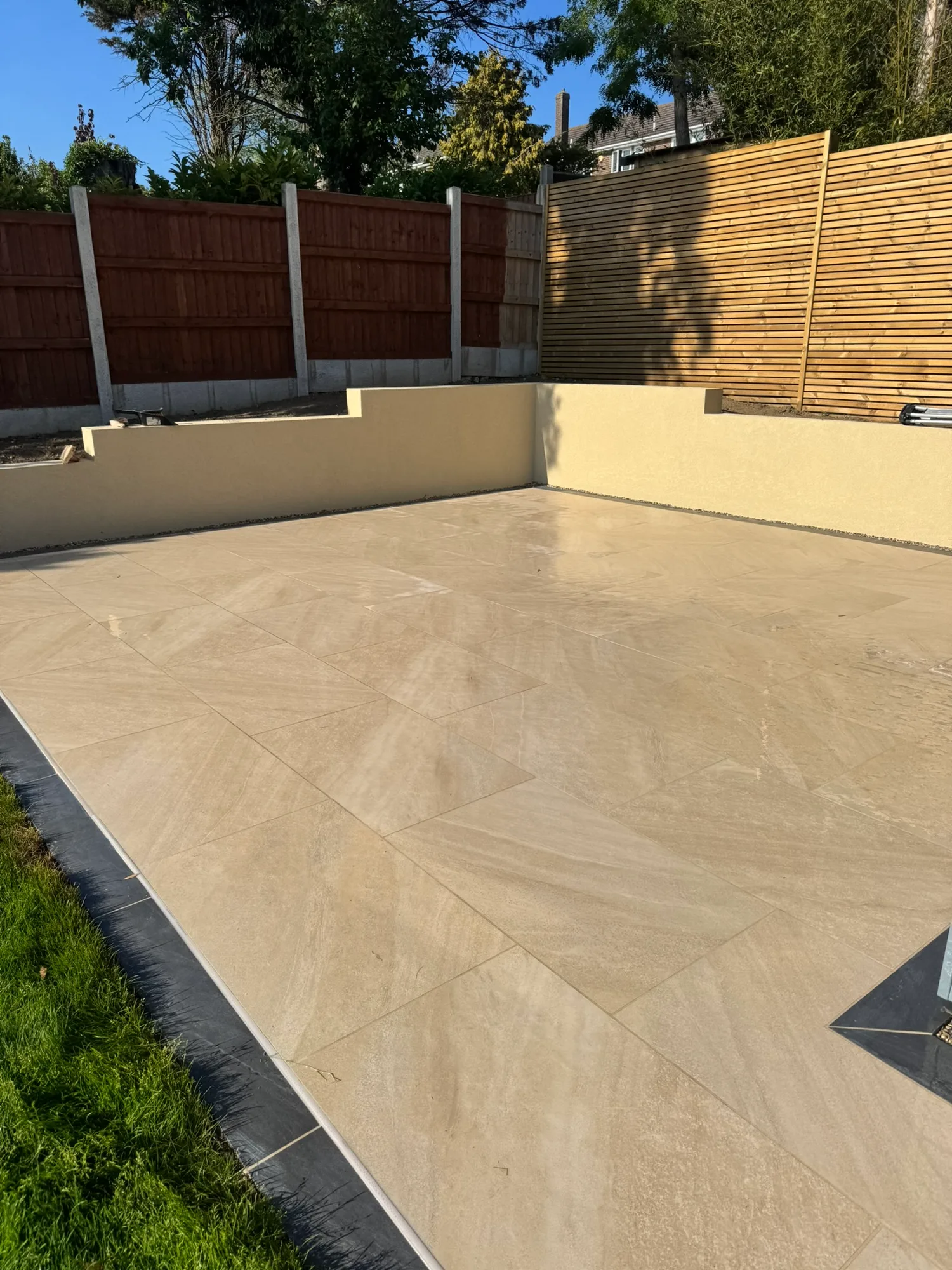Porcelain patio with rendered garden walls in Essex