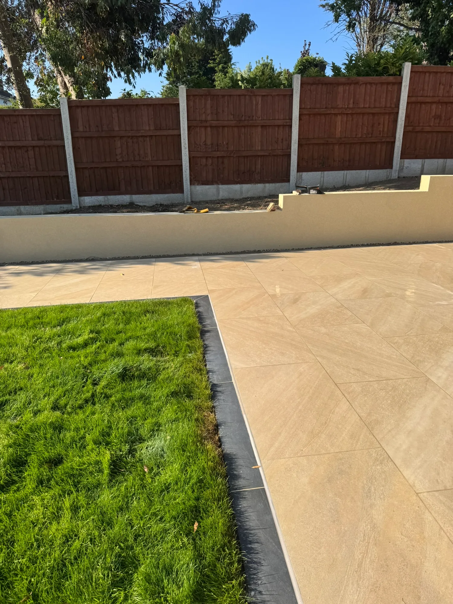 New porcelain patio and lawn edging in a landscaped Essex garden