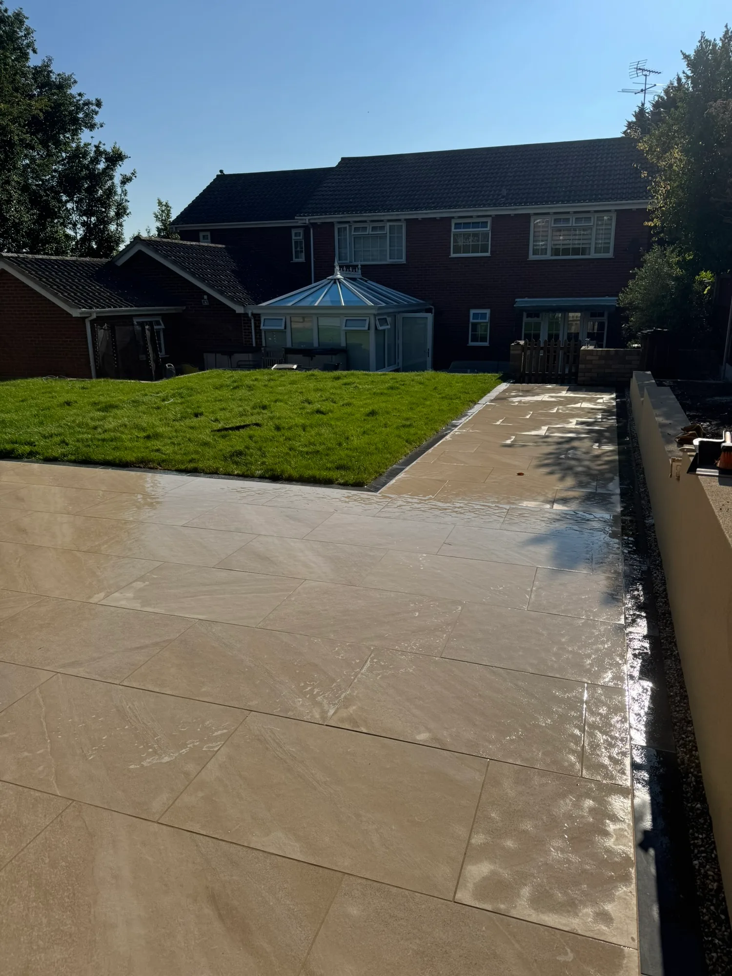 Porcelain patio and turf laid behind a home in Essex